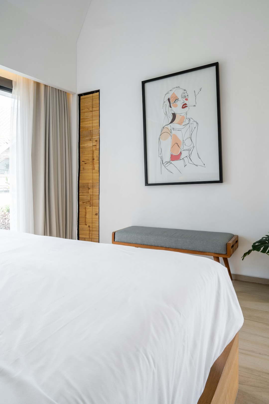 Serene minimalist bedroom with white furniture and warm morning light