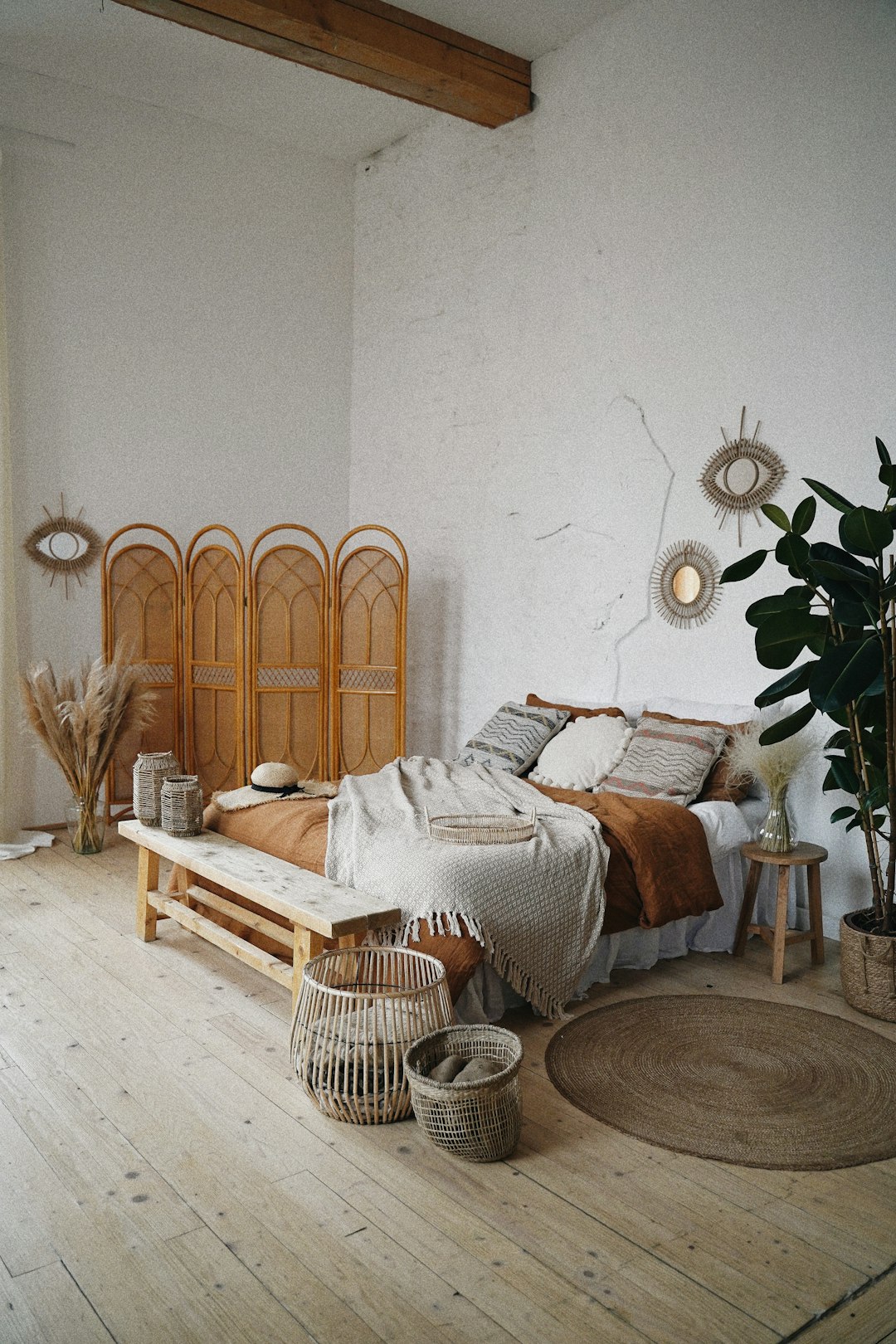 Dreamy boho bedroom corner with rattan lamp, macrame, and trailing plants