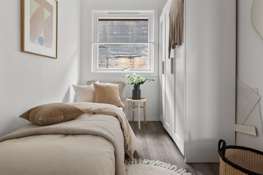 Cozy small bedroom for couples with sage green wall and linen bedding