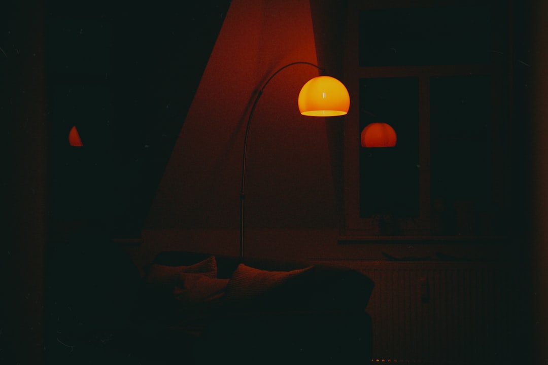 Masculine bedroom at golden hour with linen bedding and leather journal