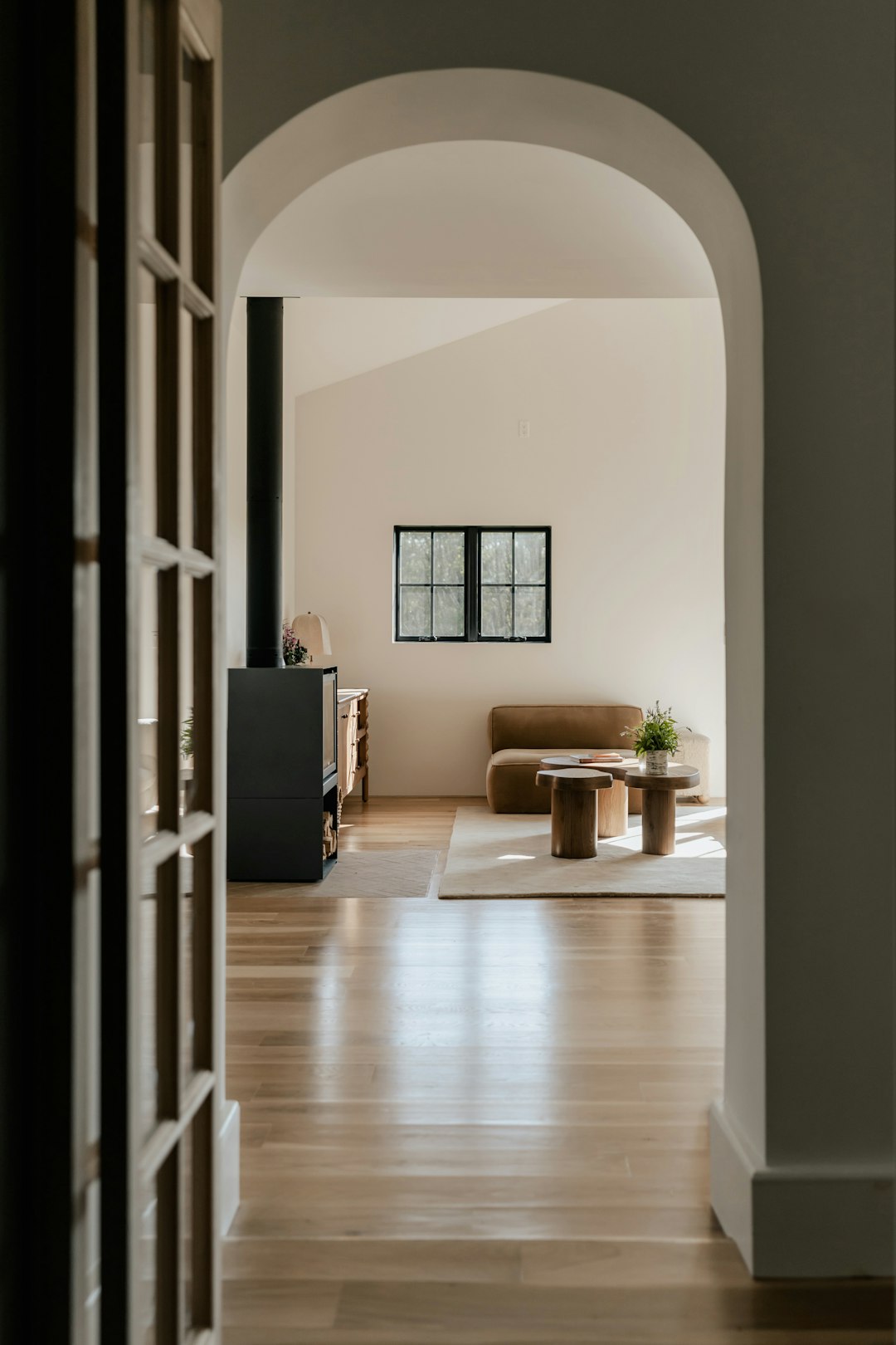 Cozy living room vignette with dark floors and bouclé chair