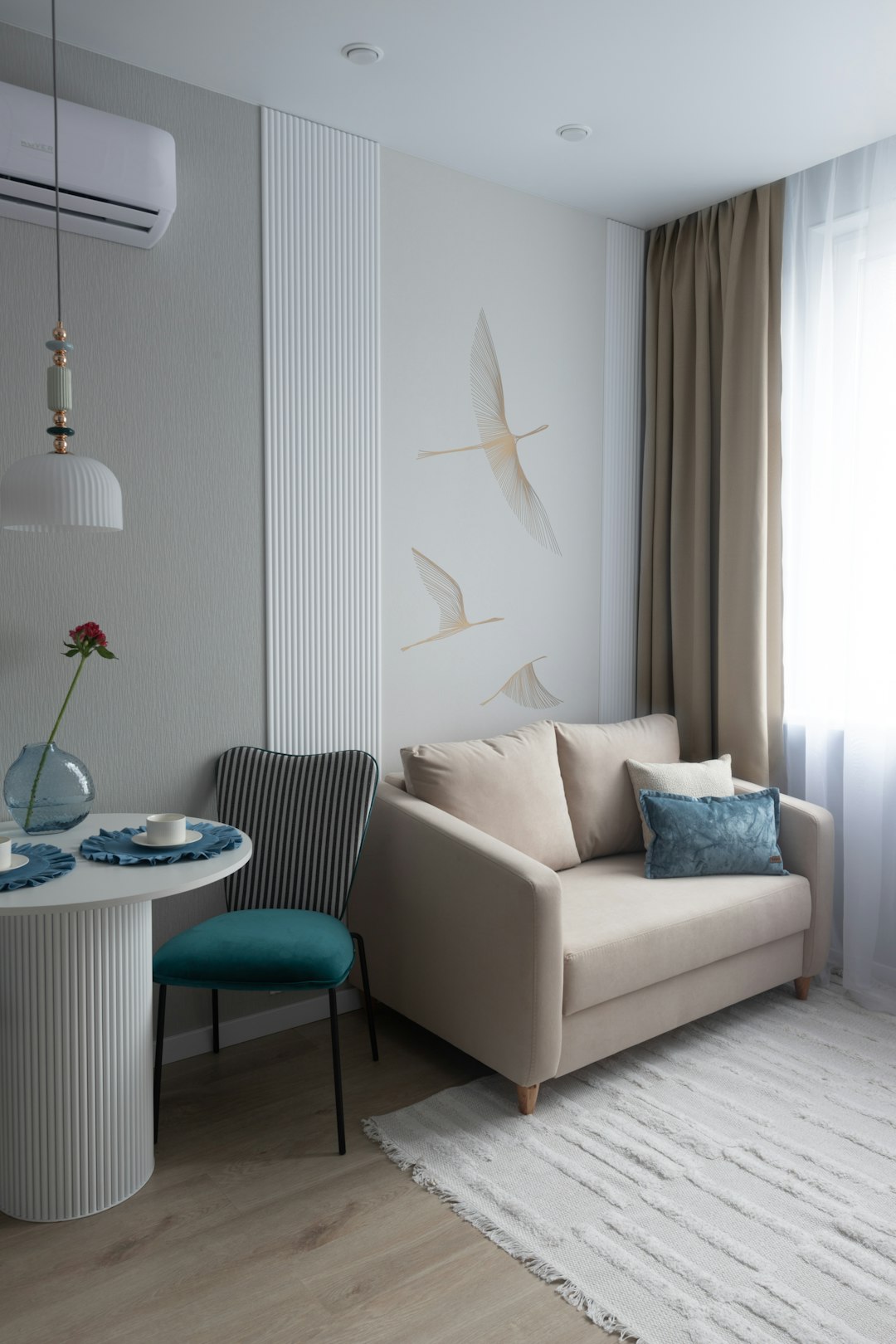 Bright small apartment living room with boucle sofa and oak shelving