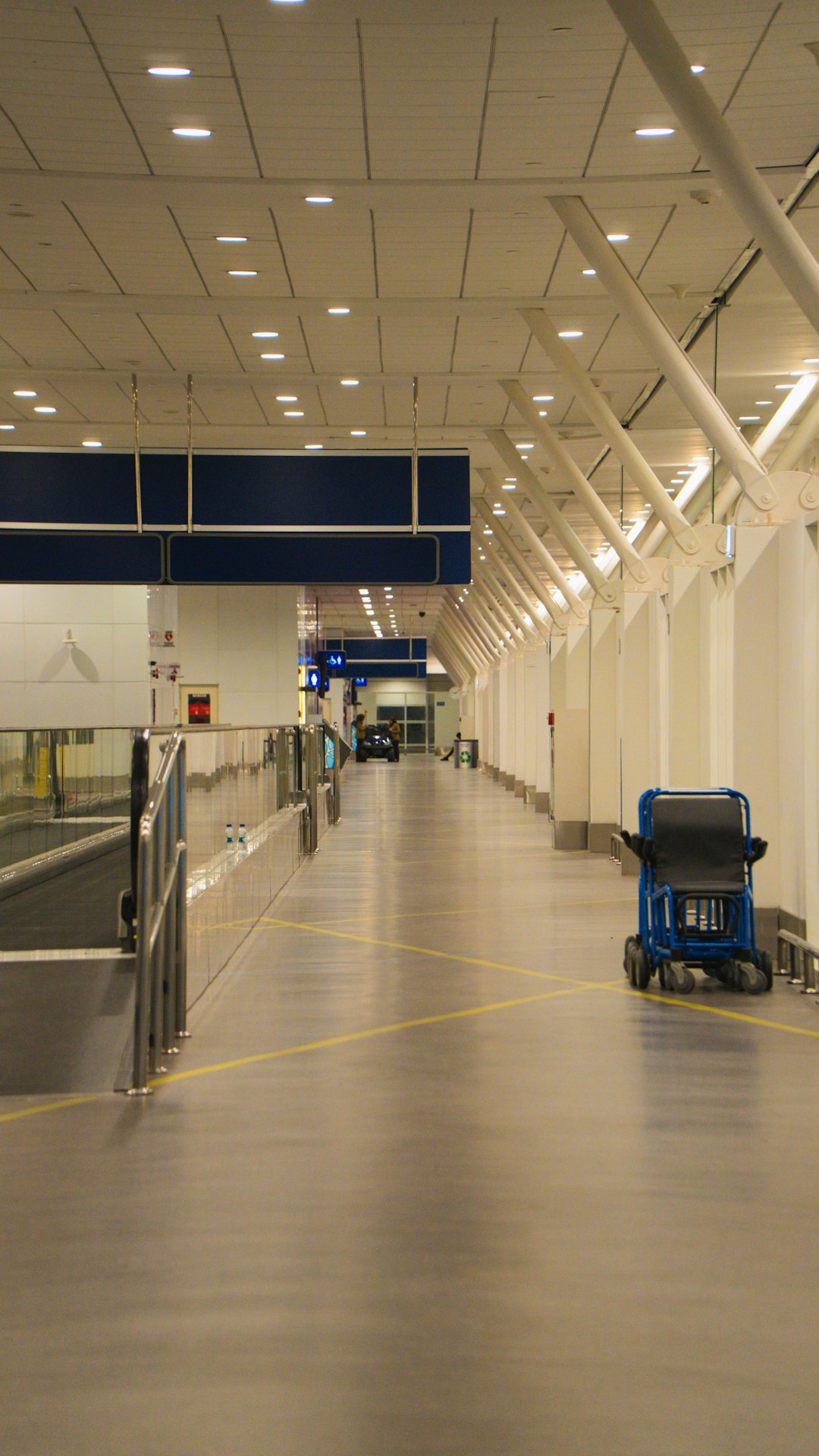 Solo traveler walking through sunlit airport corridor toward gate