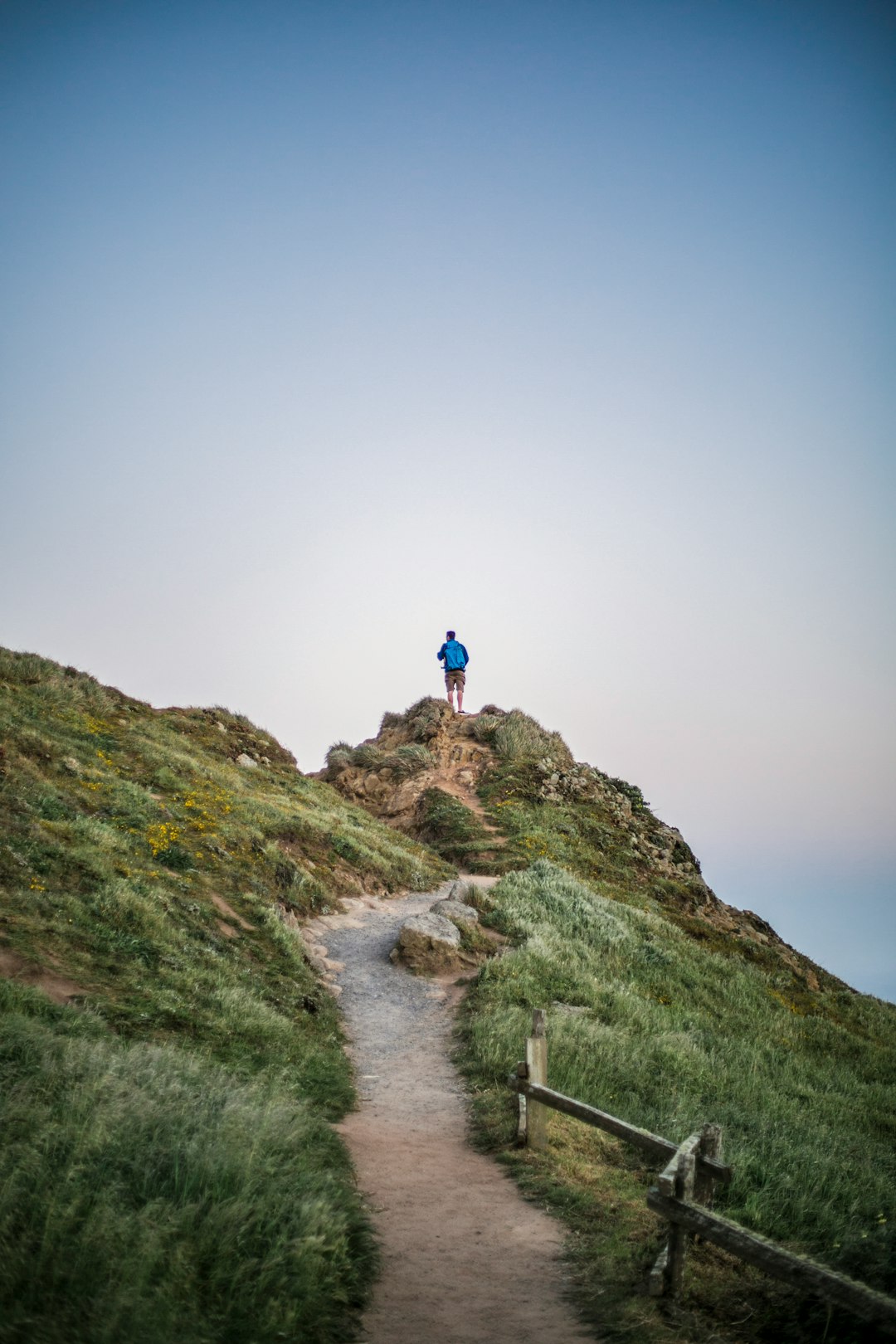 Confident hiker at mountain trailhead at sunrise