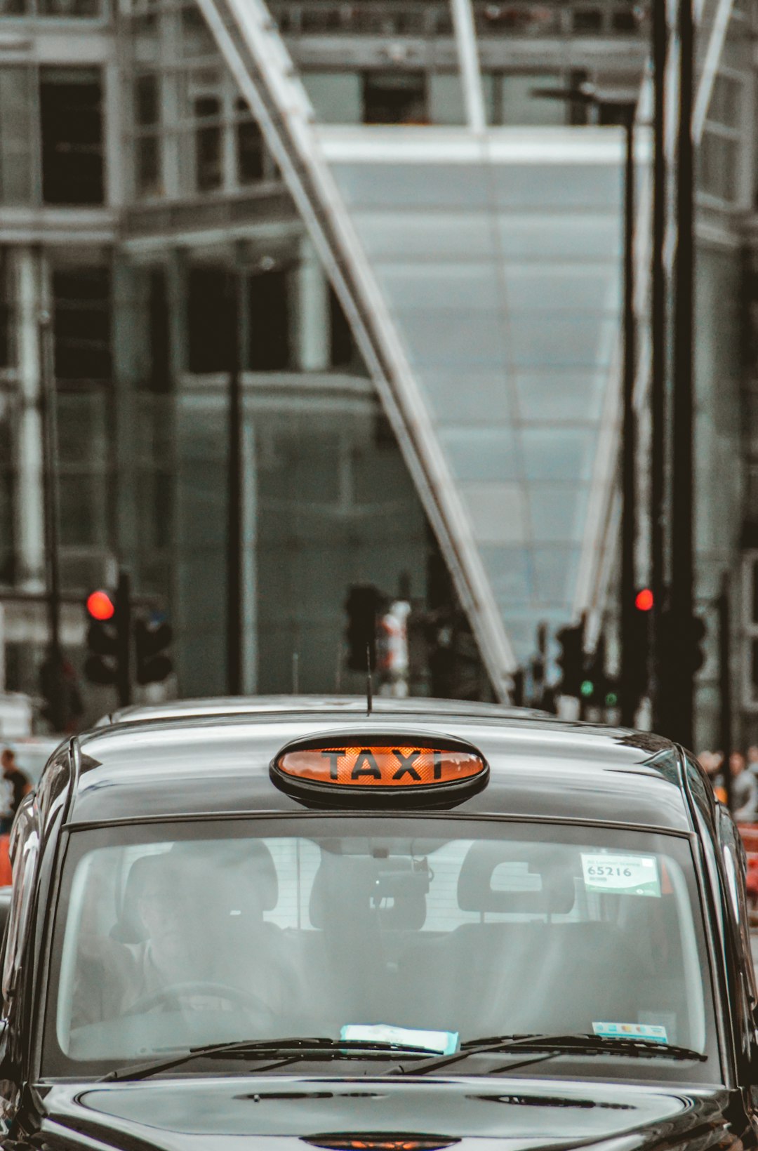 Green London taxi badge resting on open street atlas