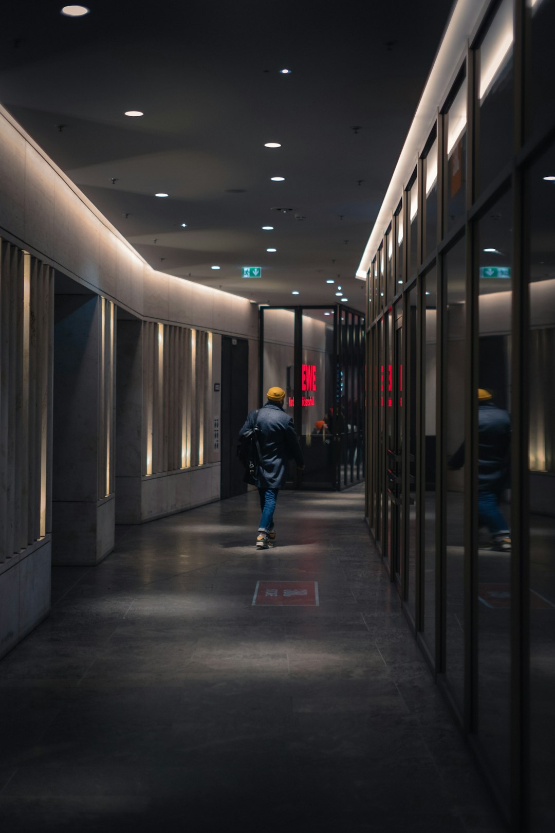 Technician walking through a tall server rack corridor