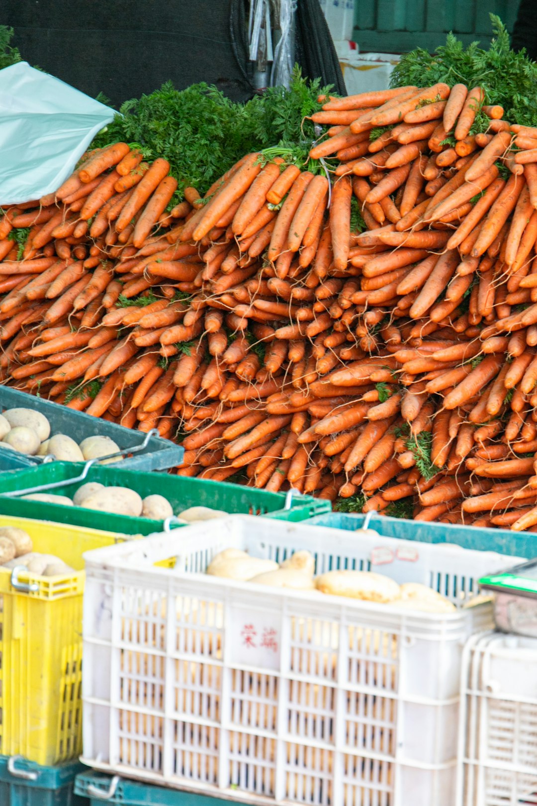 Colorful vegetables at farmers market in wooden crates