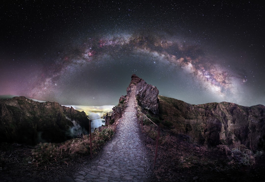 Person on mountain summit gazing at the Milky Way