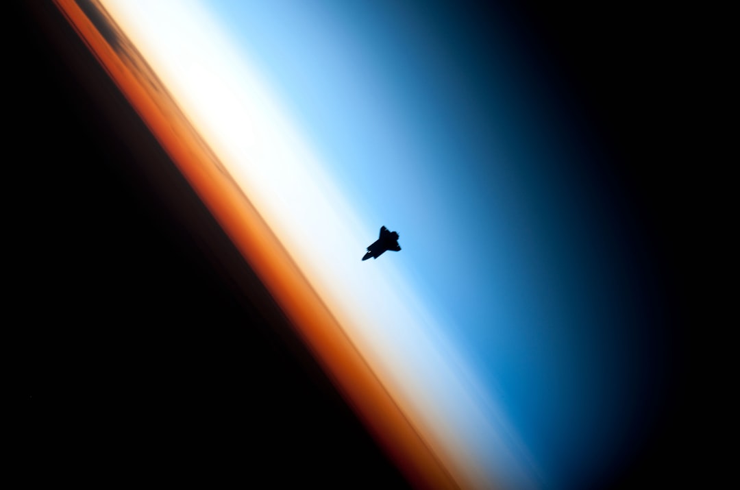 Satellite orbiting Earth in golden sunlight