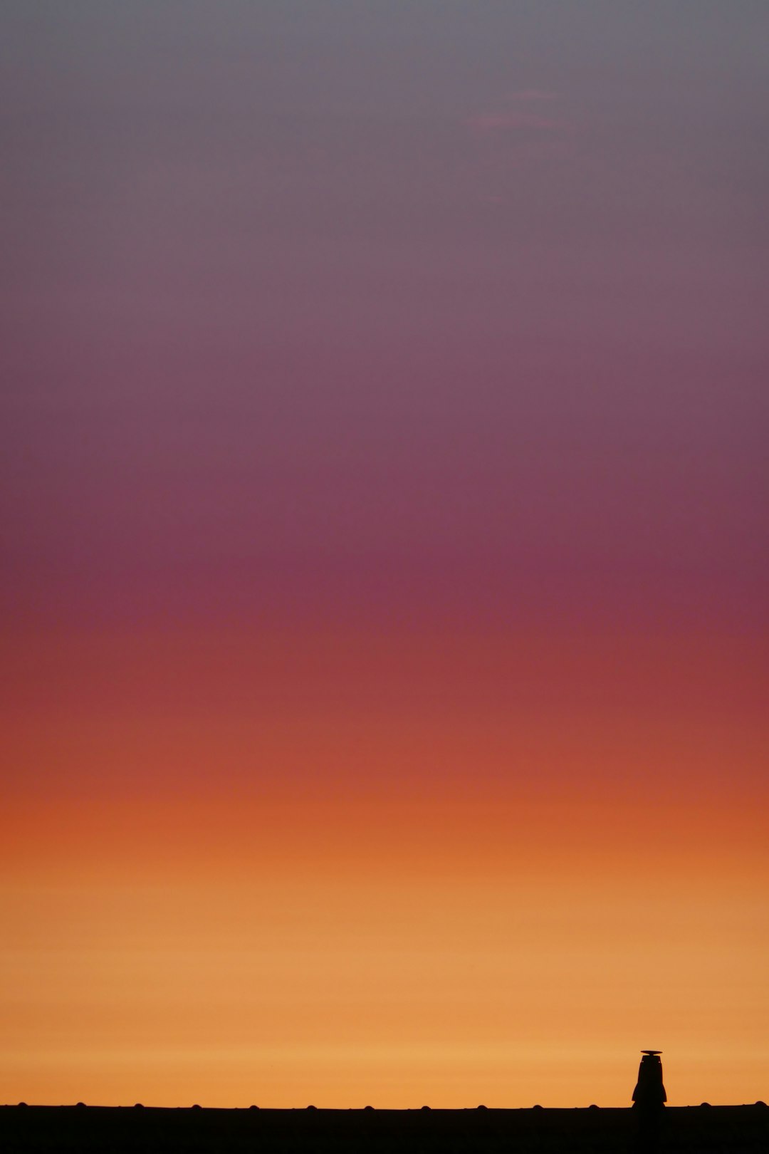 Hydrogen wellhead silhouetted against dramatic dusk sky
