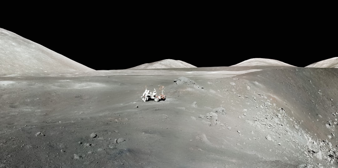 Lunar rover on the moon's surface with Earth in background