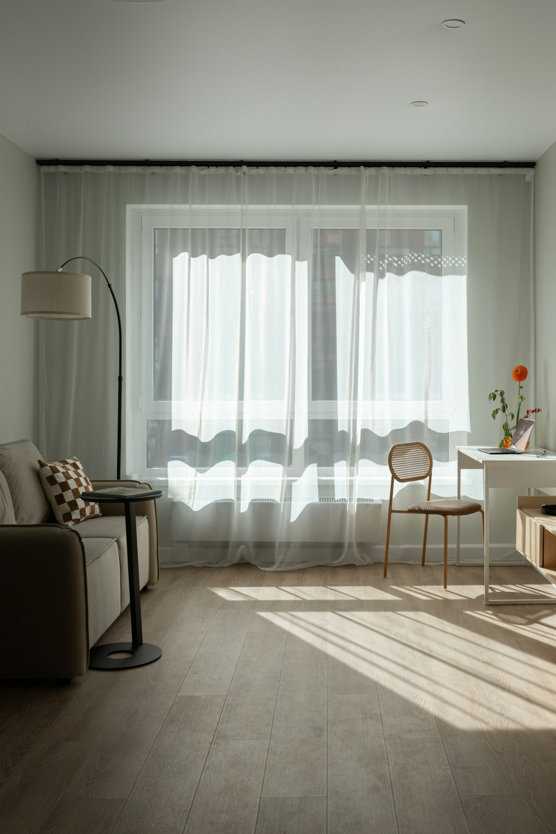 Cozy renter-friendly living room with terracotta sofa and warm lighting