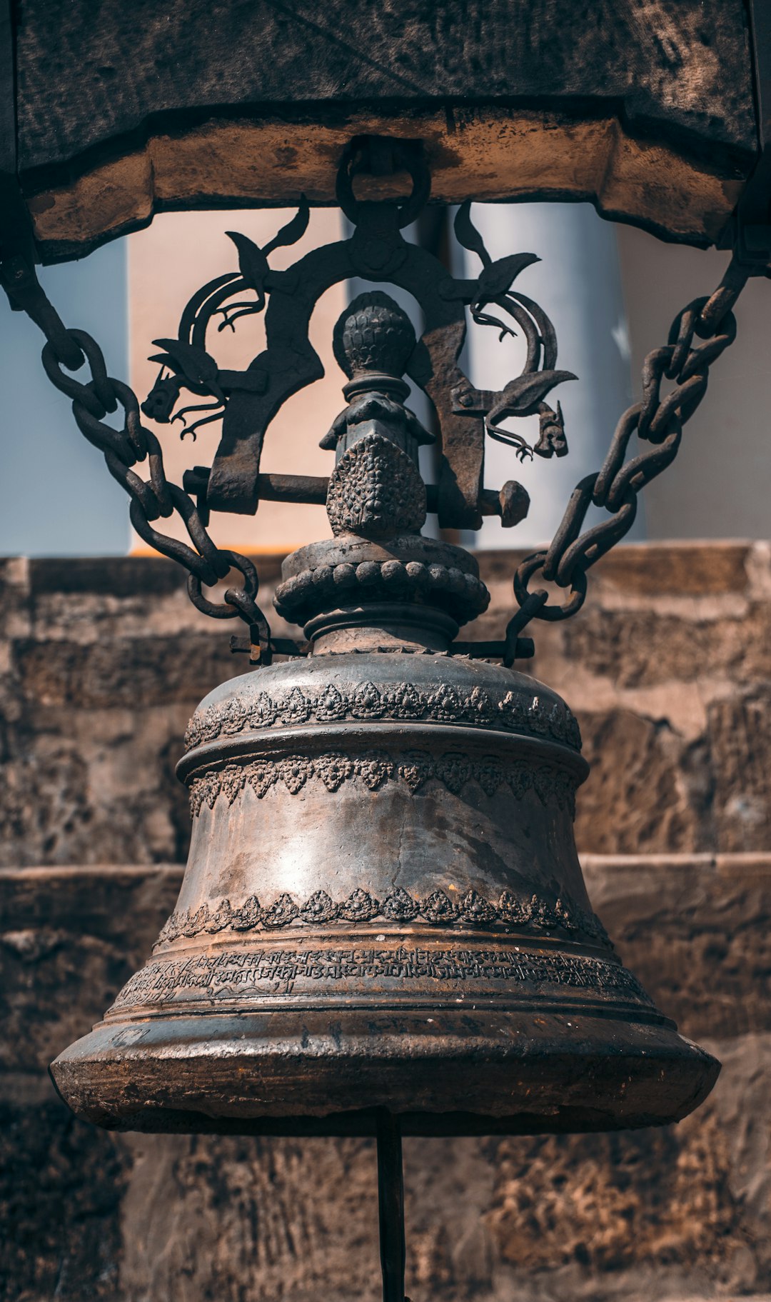 Vintage brass bell on wooden stand, dramatic lighting