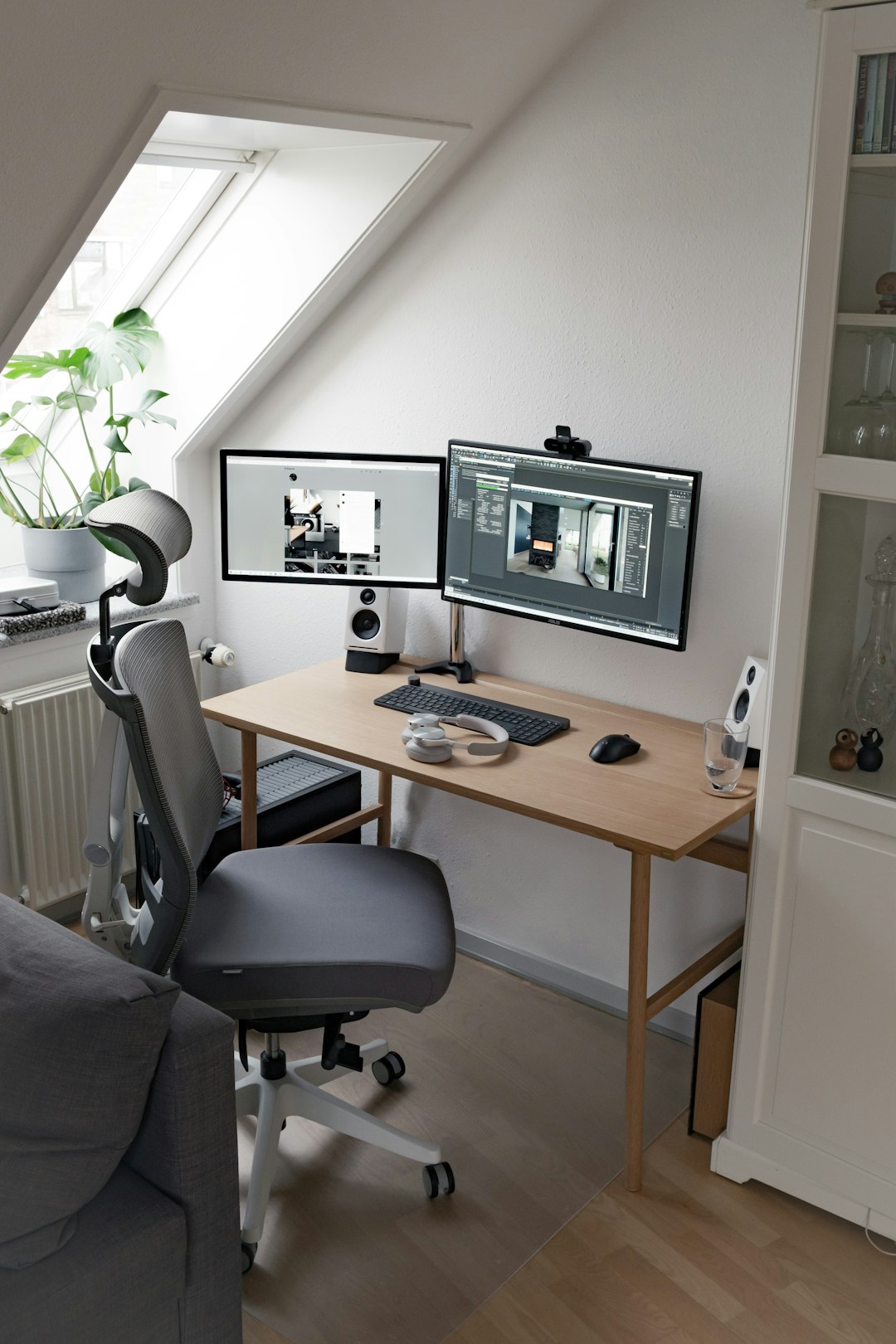 Clean dual monitor home office desk setup with warm lighting and minimal decor