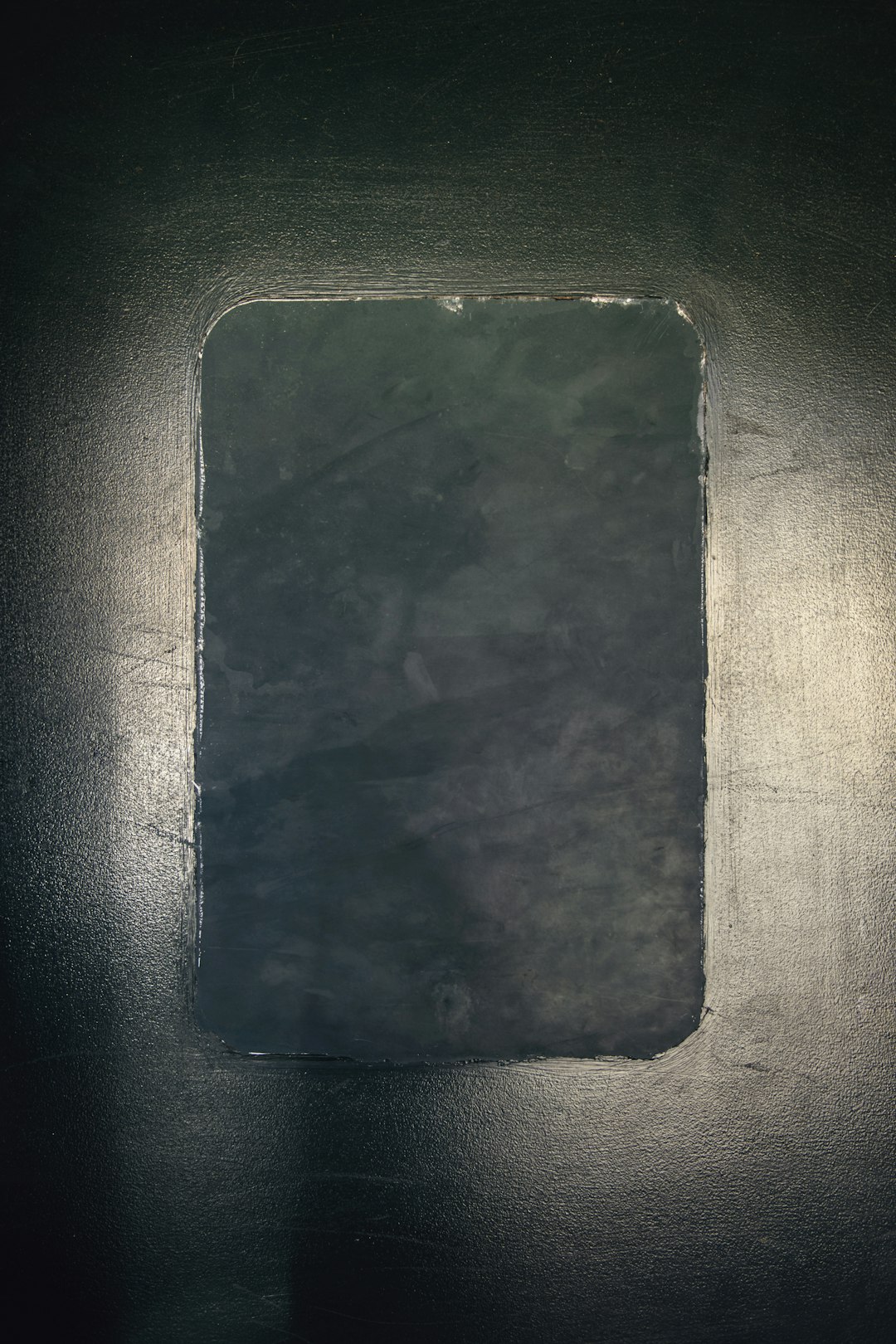 Old cracked smartphone standing alone in dramatic lighting