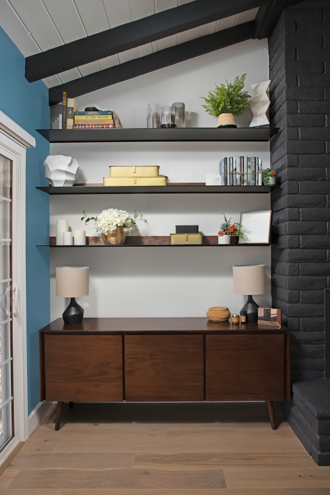 Pinterest-style vertical shot of styled dark walnut home office shelf wall