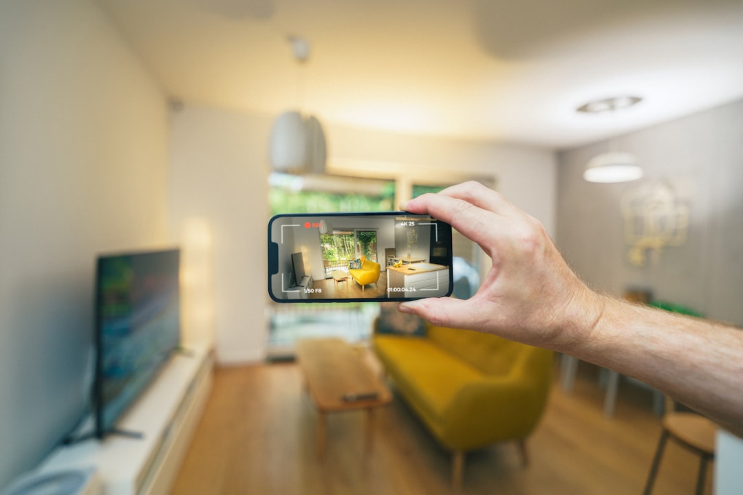 Person using AR app to place virtual sofa in living room