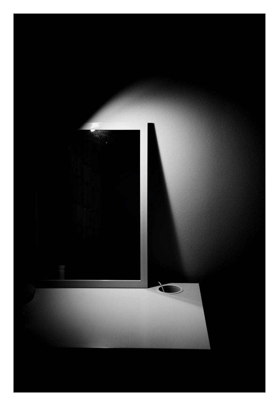 Glowing AI chat screen reflected in dark glass surface