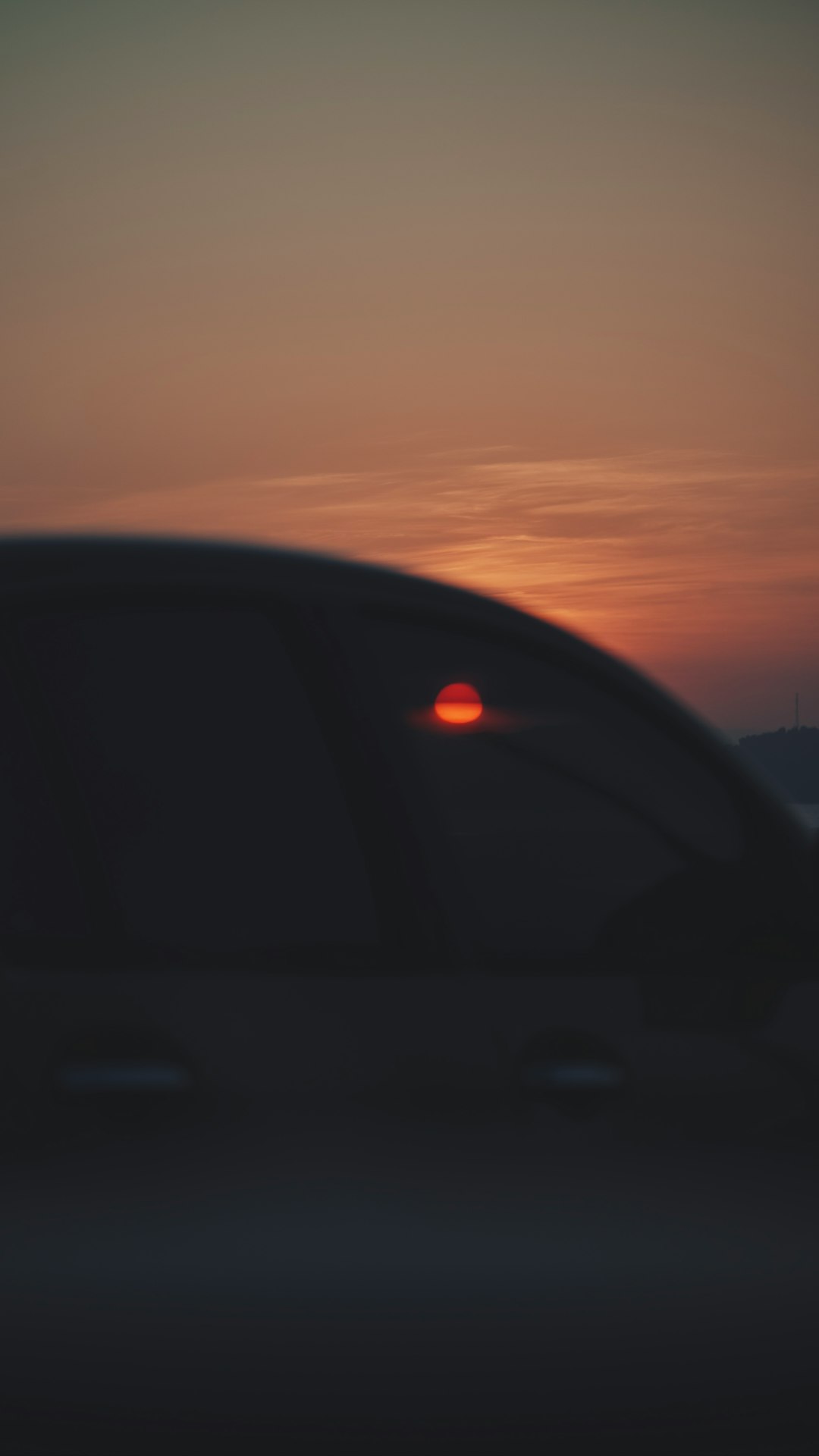 Electric vehicle charging at sunset, vertical format