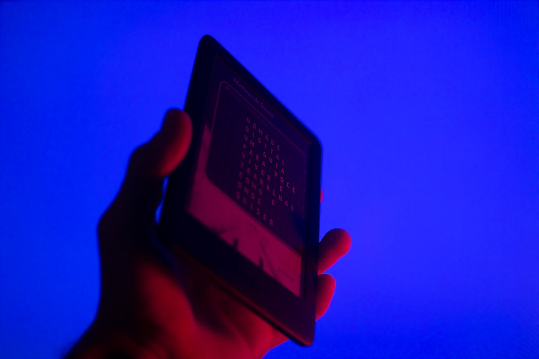 Hand holding phone with data streams flowing away