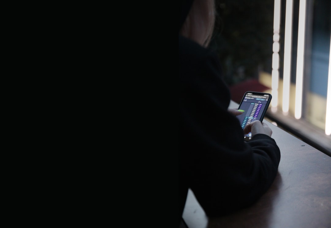 Person silently scrolling social media in dark room