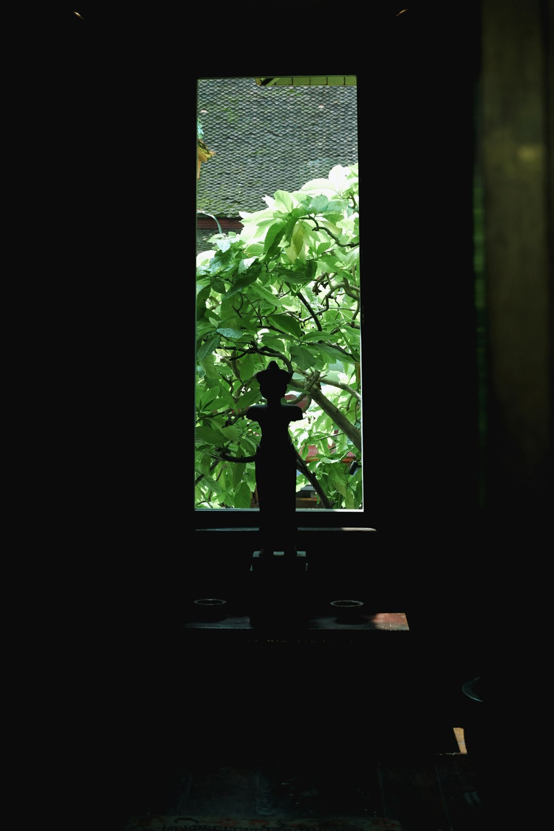 Elegant perfume bottle on windowsill with garden bokeh