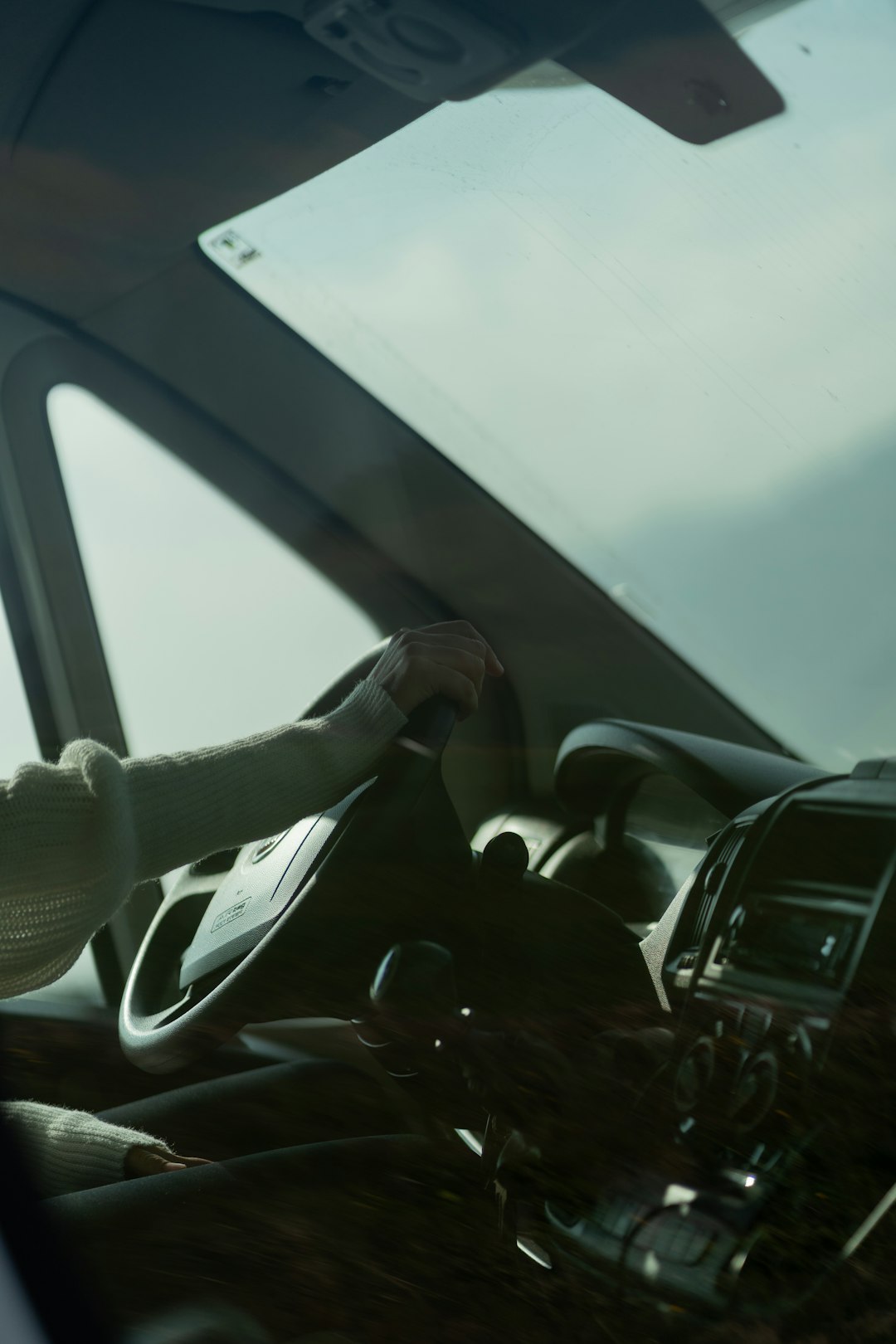 Hands hovering over autonomous car steering wheel