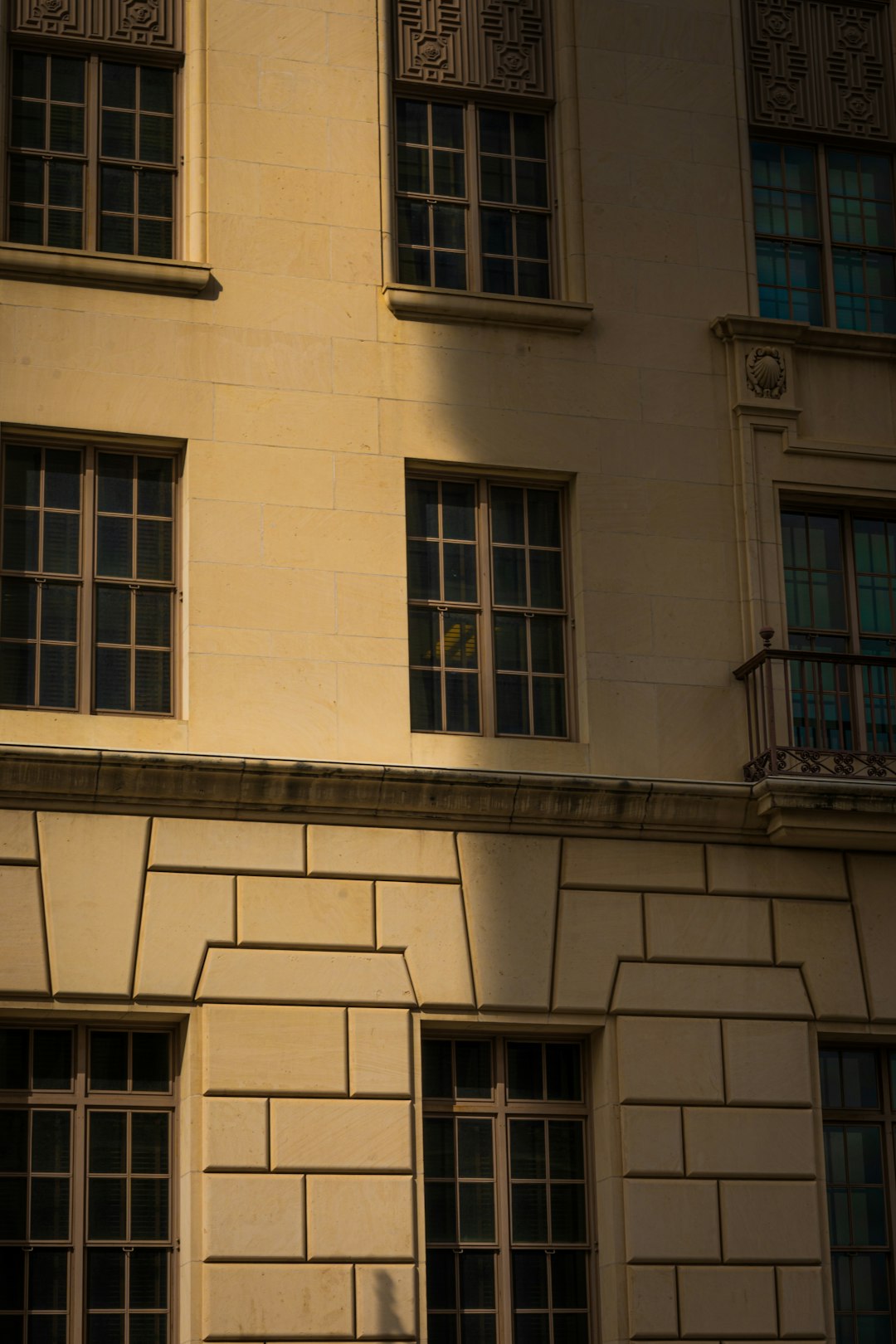 Person standing at home office window overlooking city