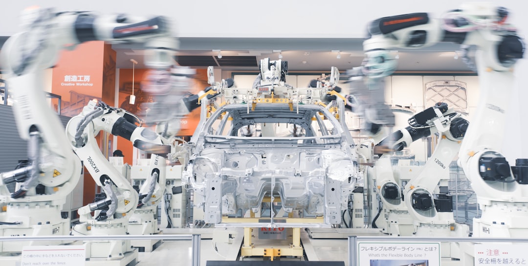 Humanoid robots and humans working together on factory floor