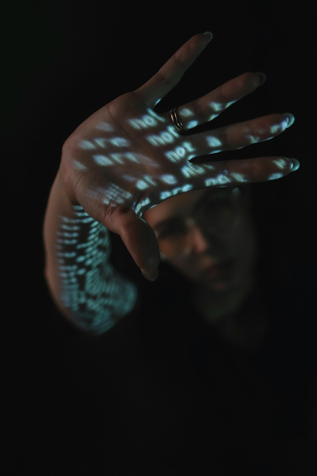 Hand reaching toward a glowing voice assistant interface