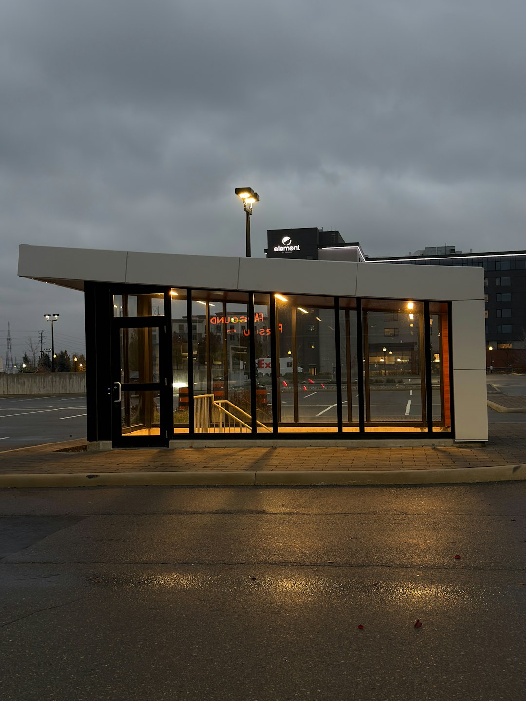 Supermarket entrance at dusk with automatic doors