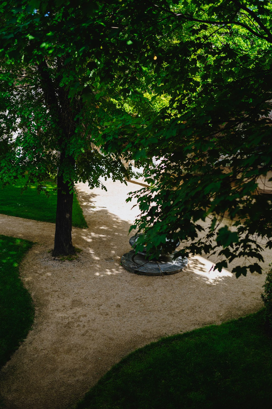 Person walking along circular stone path at golden hour