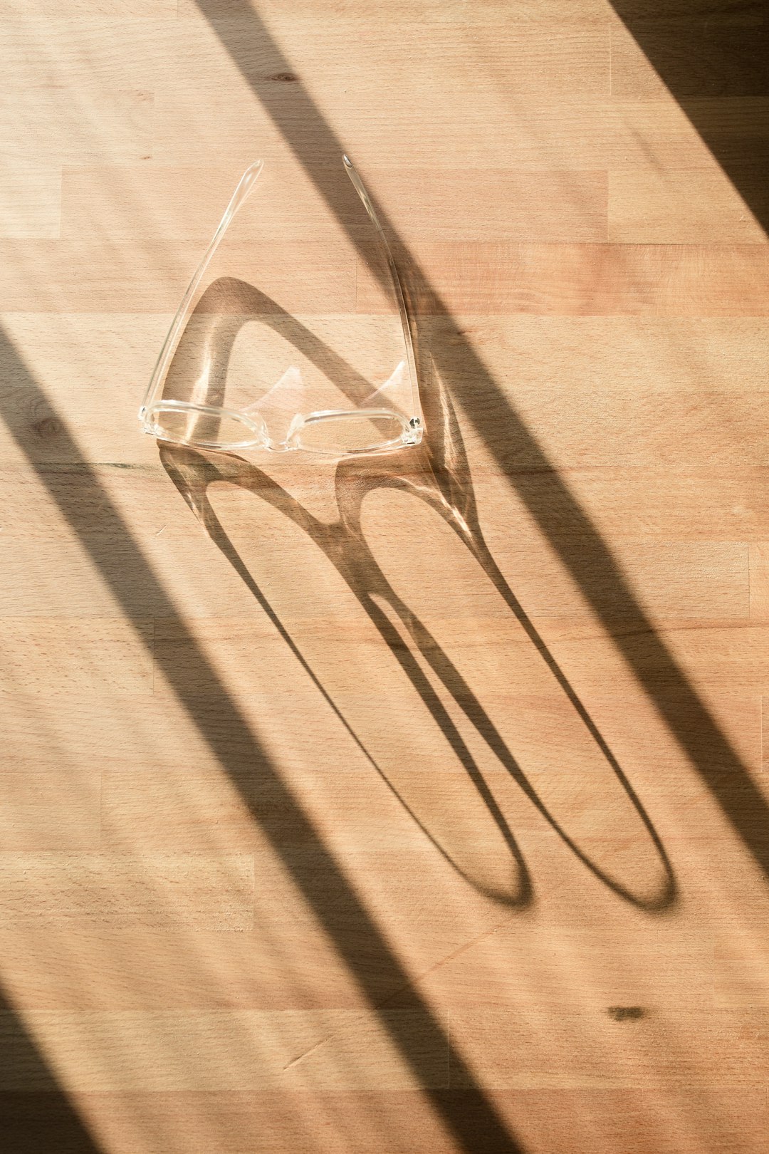 AR glasses on wooden surface near window