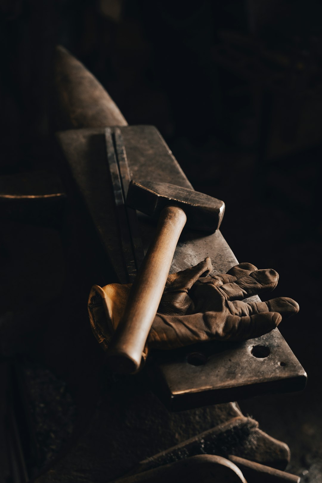 Ancient stone tools arranged on dark earth