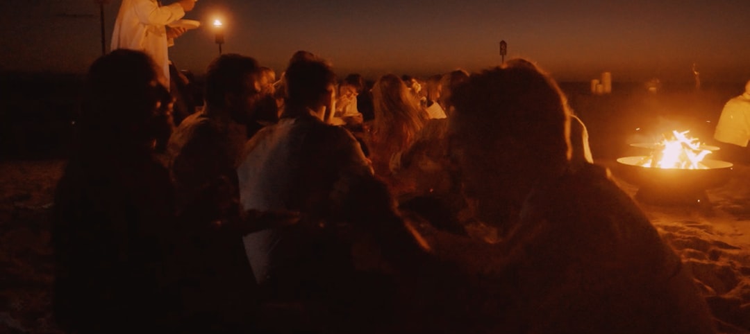 Early humans gathered around a campfire on ancient savanna