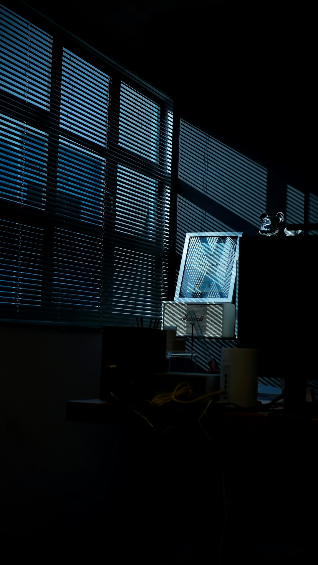 Person alone in dark room lit by AI chat screen