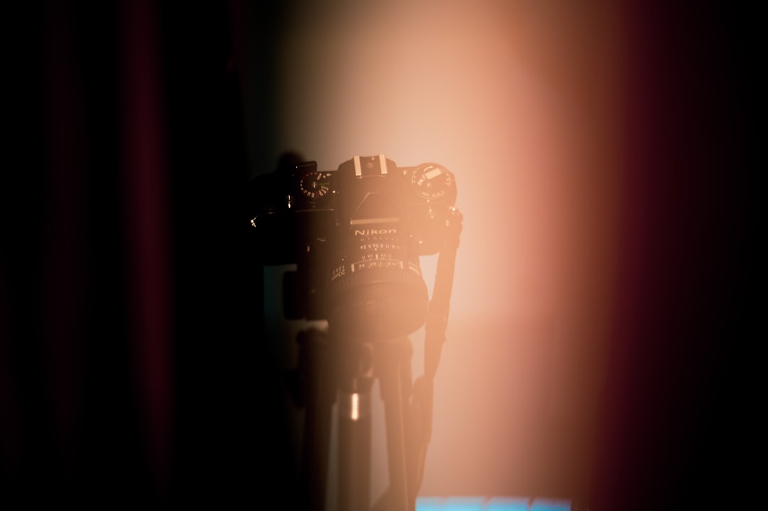 Vintage microphone surrounded by digital particles in dark setting