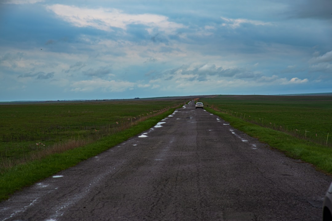 Autonomous vehicle on empty rural road at sunset