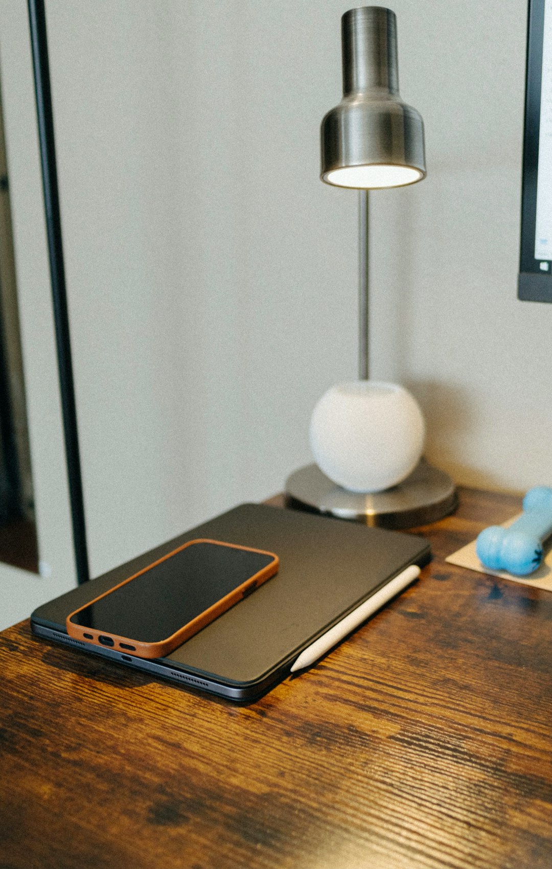 Smartphone charging on wireless pad on clean desk