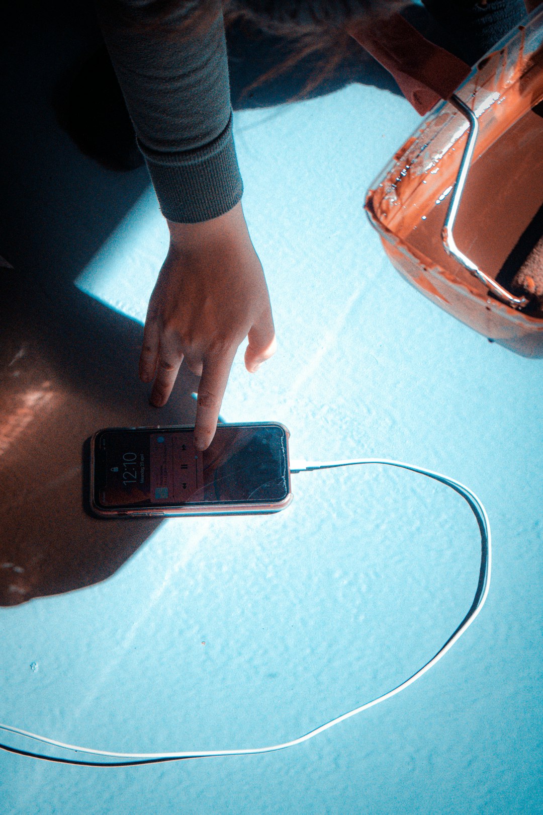 Hand placing smartphone on wireless charging pad