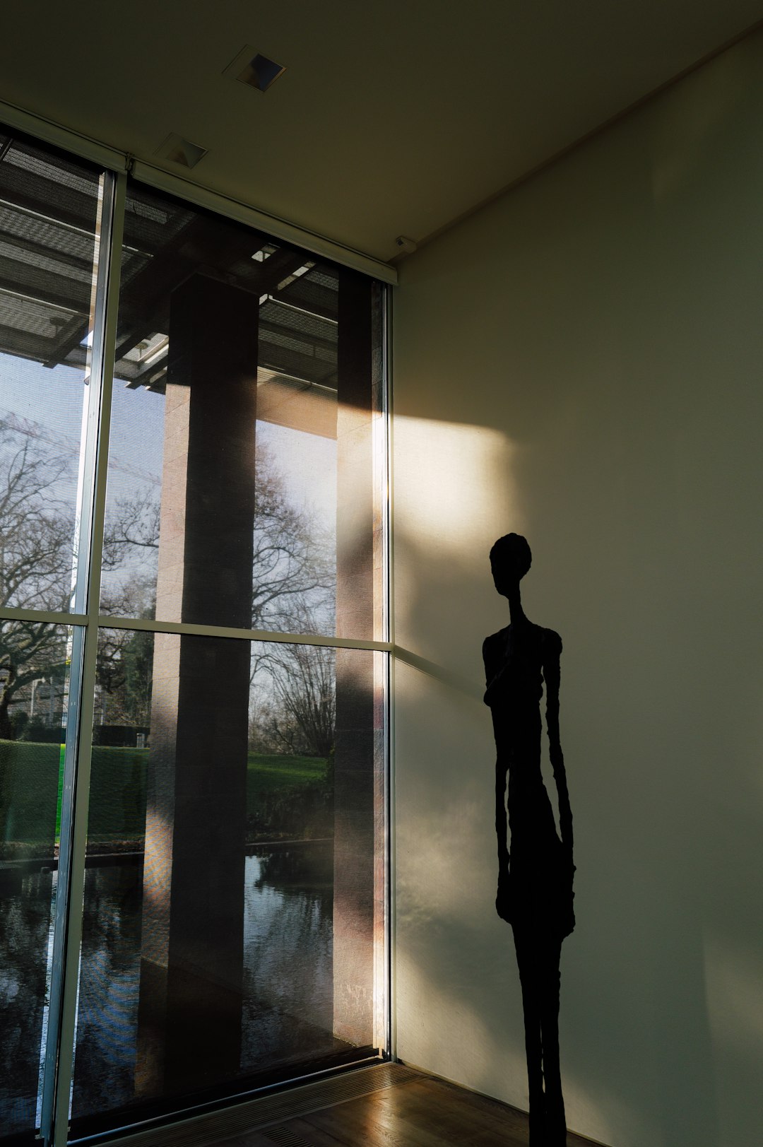 Humanoid robot silhouette standing in doorway