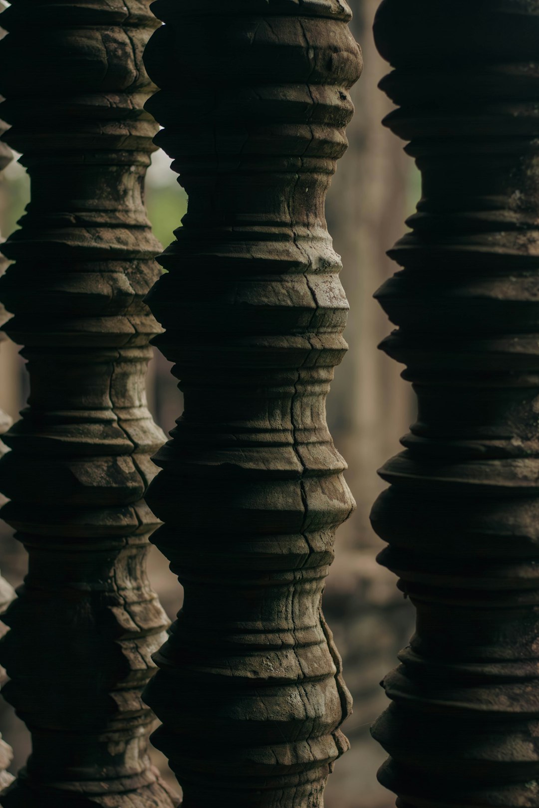 Vertical clay spiral on dark stone, dramatic lighting