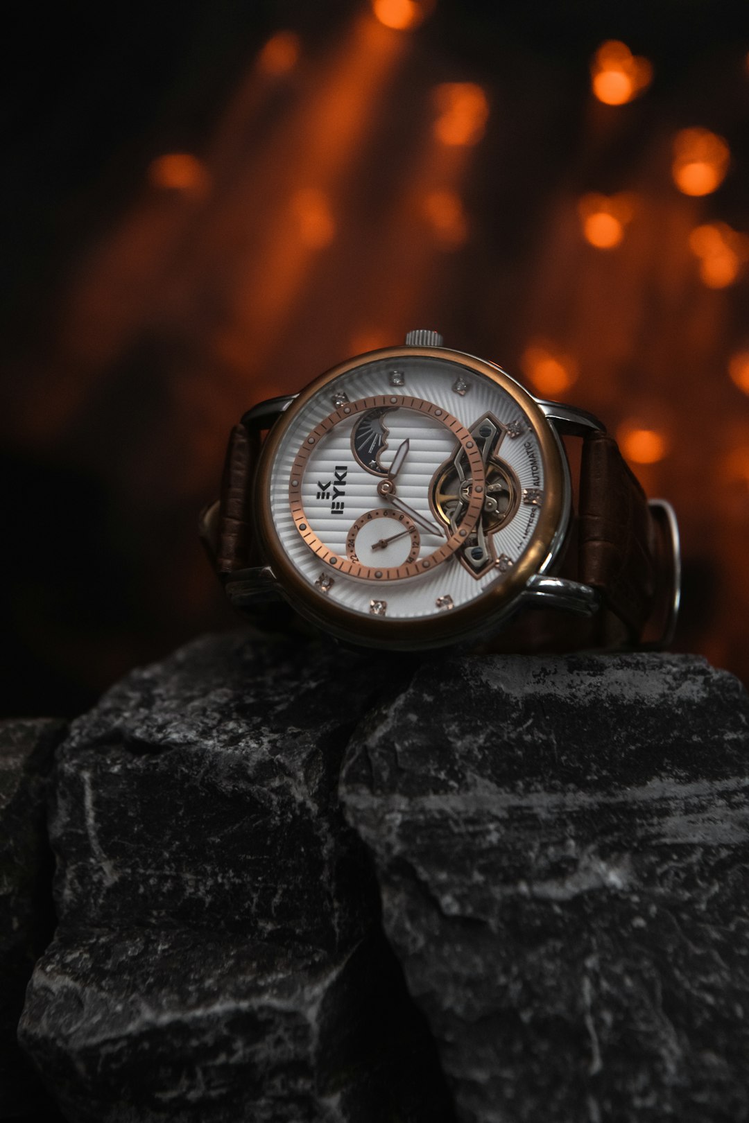 Luxury tourbillon watch against dark stone surface