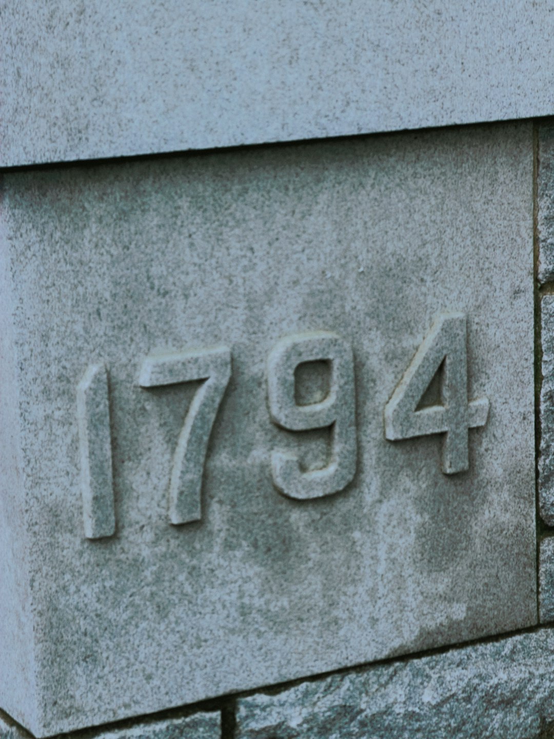 Number 142857 carved in stone with dramatic lighting