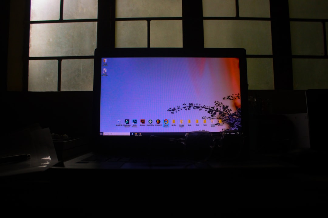Laptop showing software update progress bar at night