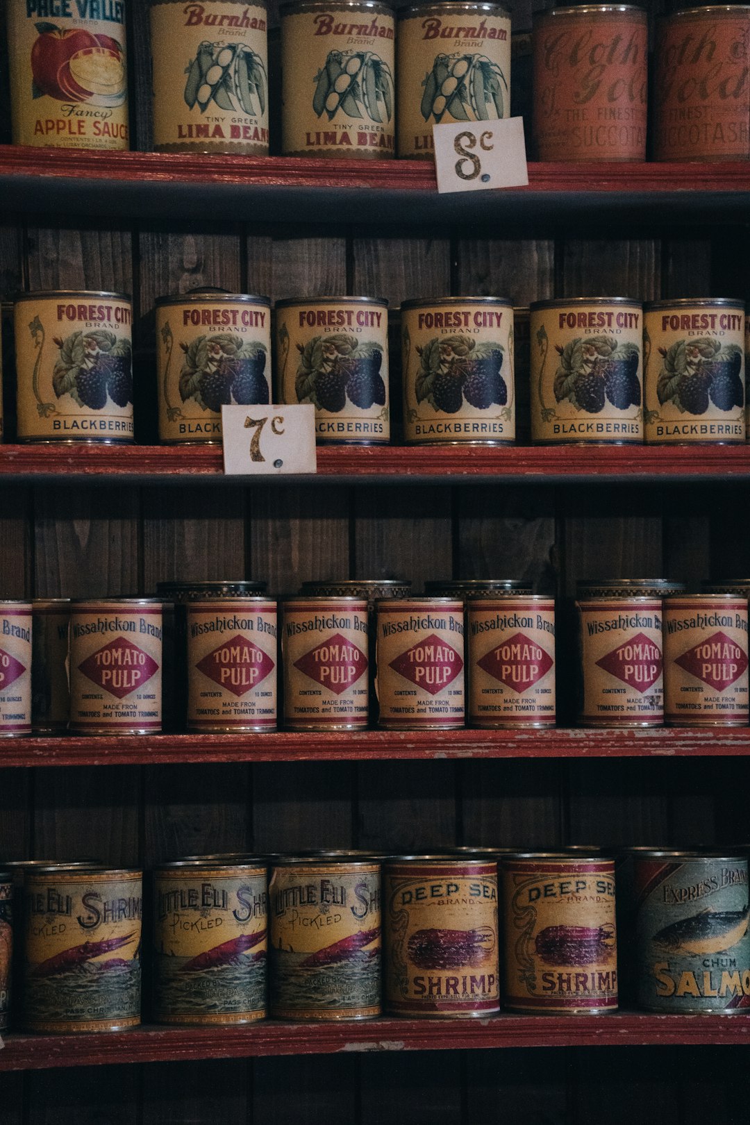 Glass jar of preserved food on a wooden kitchen shelf