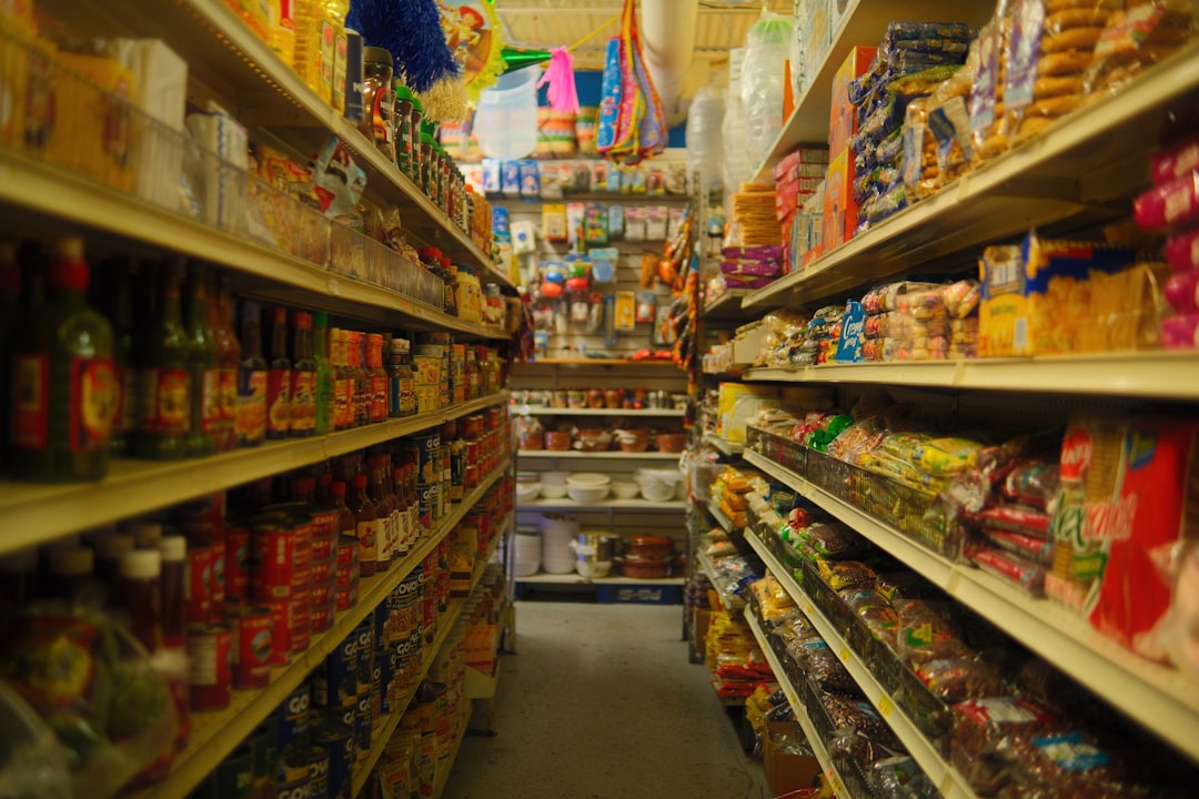 Supermarket shelves with food products showing date labels