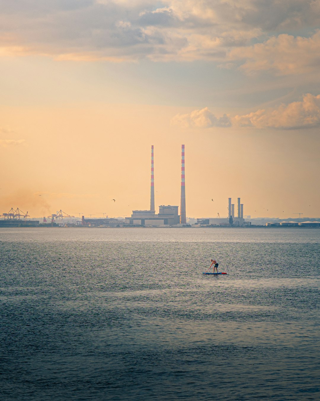 Futuristic fusion power plant at dusk by the coast
