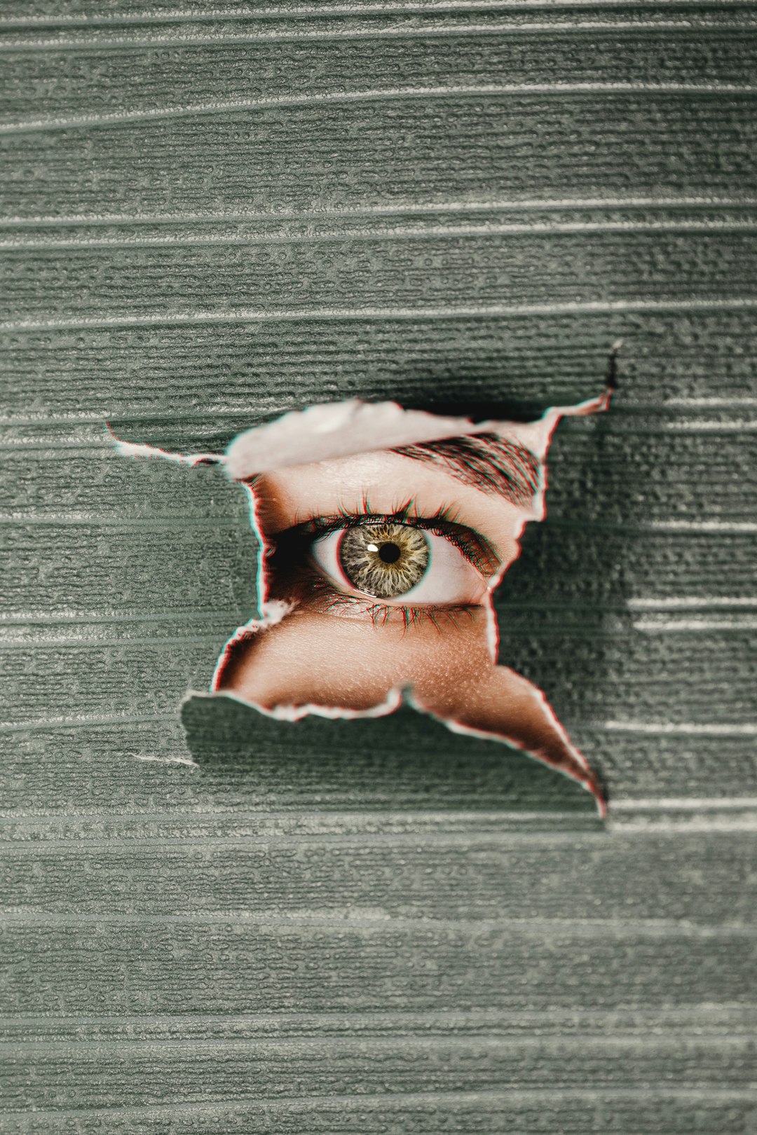 Human eye reflected in cracked mirror with digital distortion