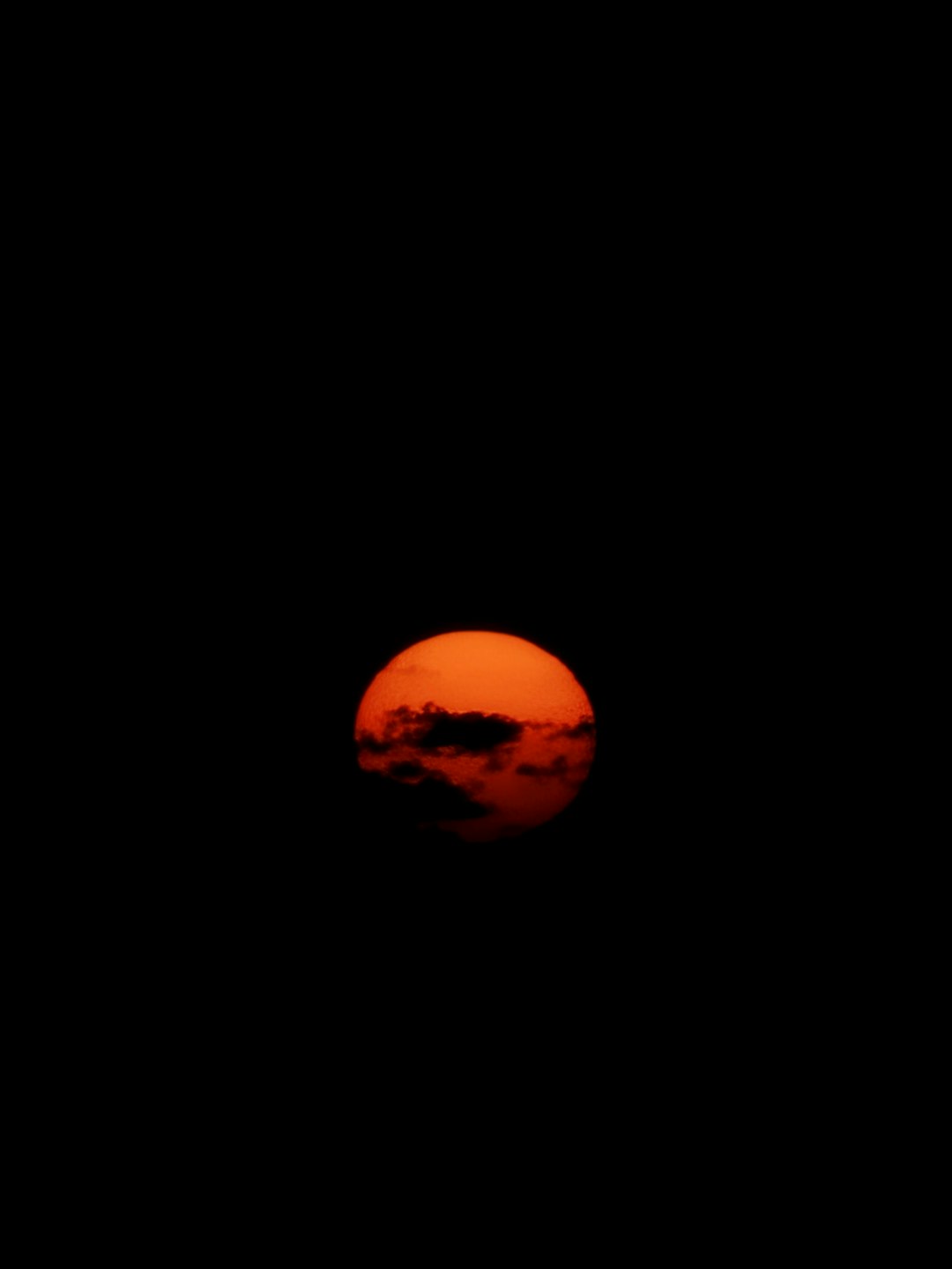 Rocky planet silhouetted against a red giant star
